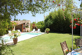 View of the pool with pool house behind